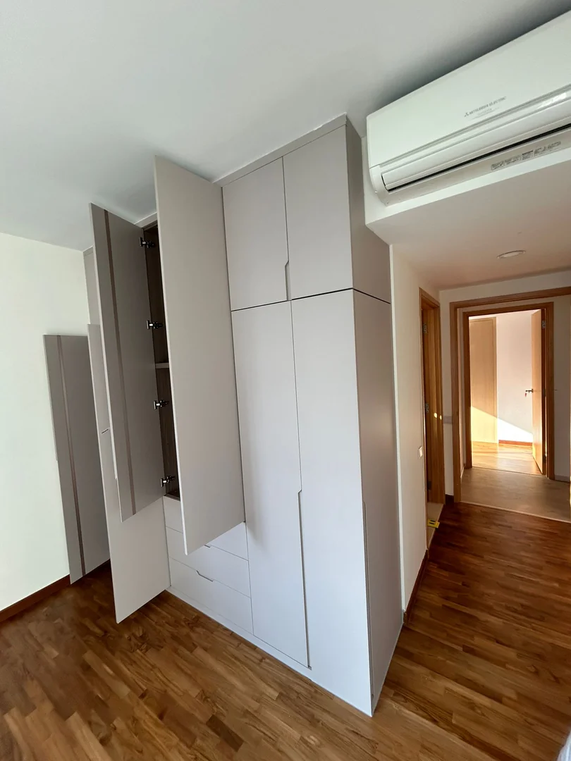 Open custom wardrobe with internal shelves and hanging space in Singapore