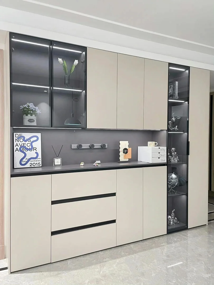Full-height cream living room storage cabinet with dark display niches in a Singapore home