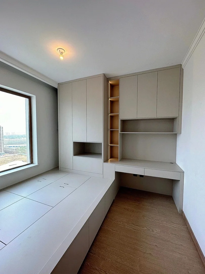 Platform bed with study table and overhead storage for a Singapore bedroom