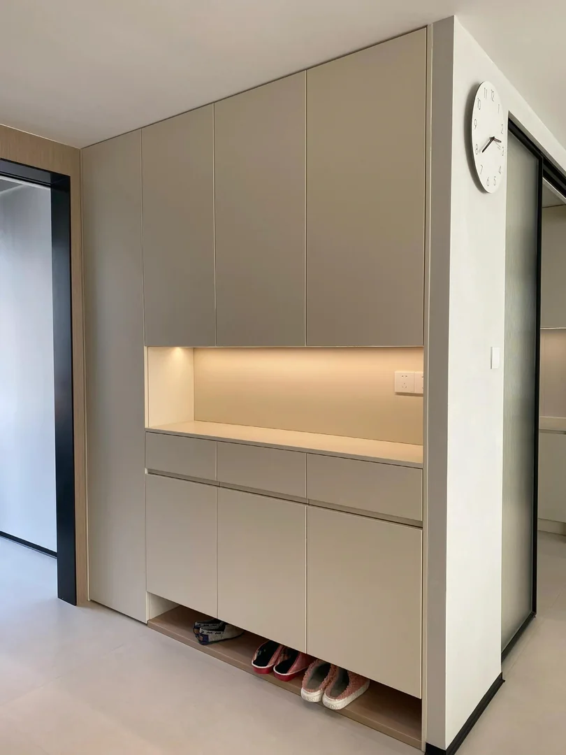 Beige full-height HDB shoe cabinet with an open display niche and ventilated lower shoe shelf
