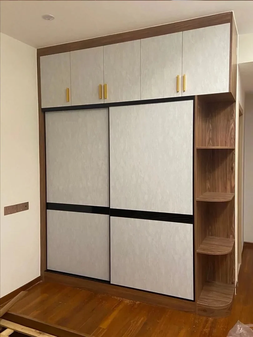 Sliding door wardrobe with open shelf storage in a Singapore bedroom